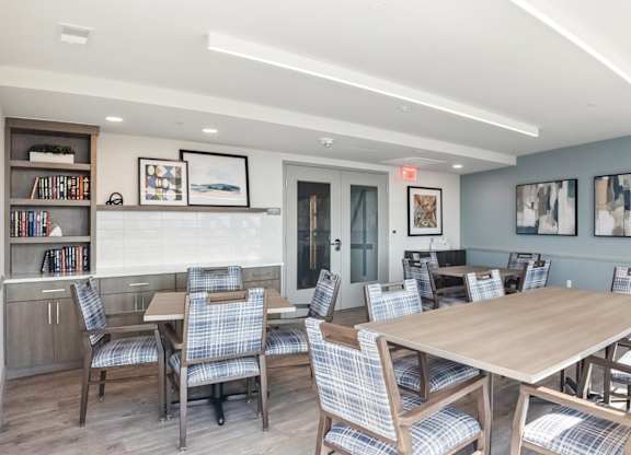 A dining room with a wooden table and chairs.