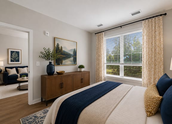 A bedroom with a large bed and a painting on the wall.