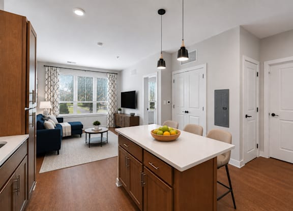 A kitchen with a table and chairs in the middle of the room.