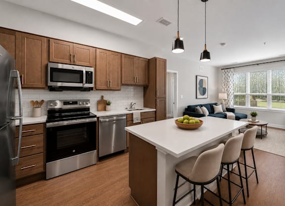 A modern kitchen with a large island and bar stools.
