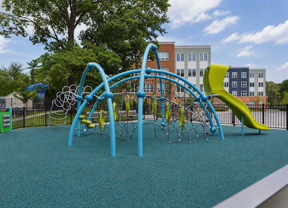 A playground with a blue and green play structure.