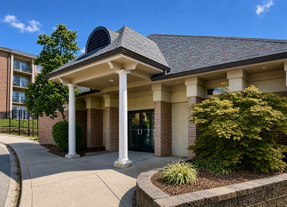 A building with a grey roof and white columns.