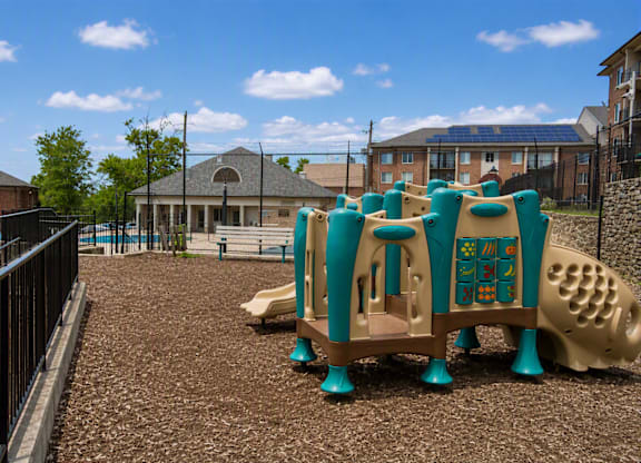 A playground with a slide and a play structure.