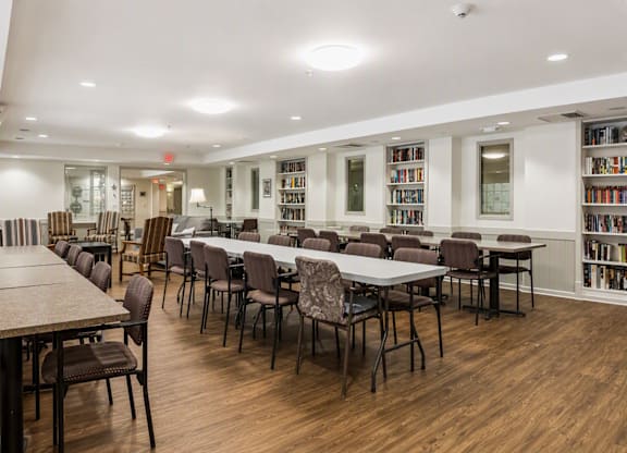 A library with tables and chairs and bookshelves.