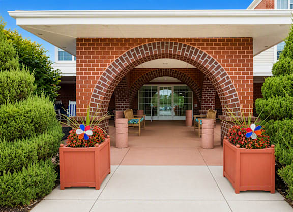 A red brick archway leads to a building entrance.