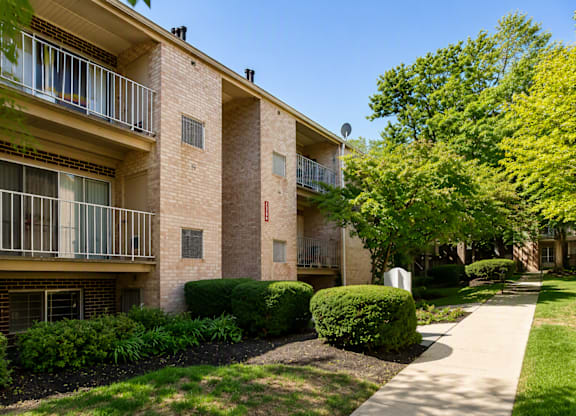 Apartment building with a walkway in front.