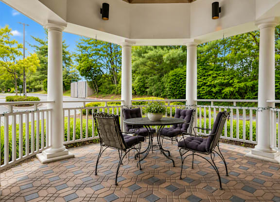 A patio with a table and chairs.