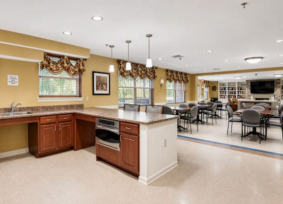 A kitchen with brown cabinets and a white island.