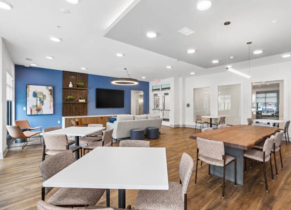 A modern dining area with wooden tables and chairs.