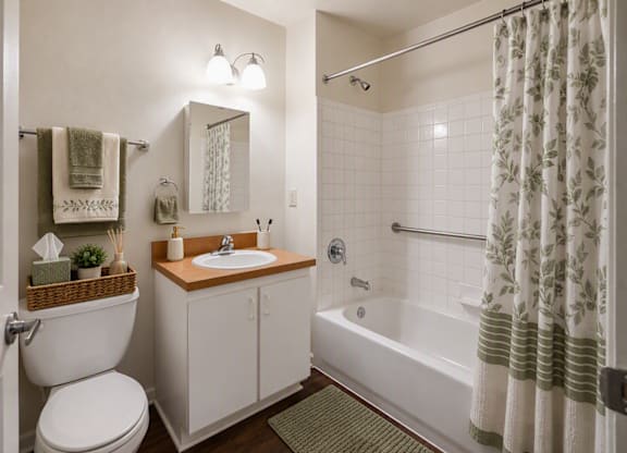 A white bathroom with a toilet, sink, and bathtub.