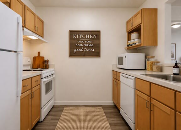 A kitchen with a sign that says "Kitchen" on the wall.