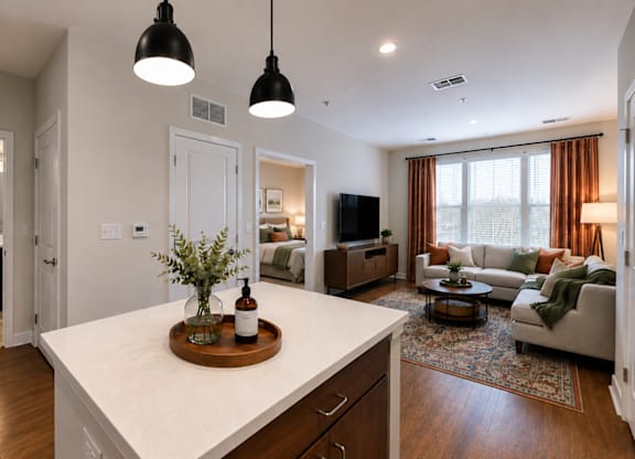 A modern kitchen with a white countertop and wooden cabinets.