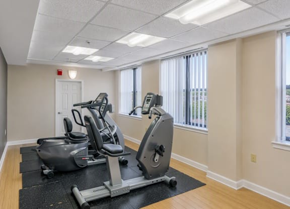 A room with a treadmill and a stationary bike.