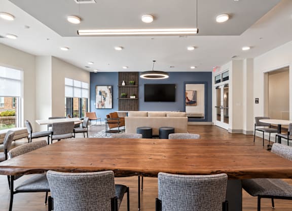 A conference room with a long table and chairs.