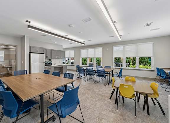 A conference room with a large table surrounded by chairs.