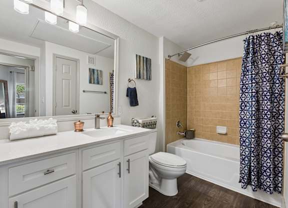 A bathroom with a white toilet and a white sink.