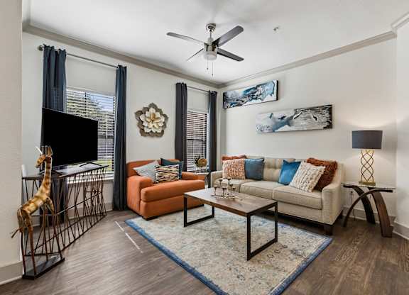 A living room with a giraffe sculpture and a sofa.
