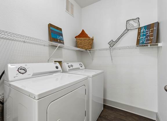 A white washing machine and dryer in a small laundry room.