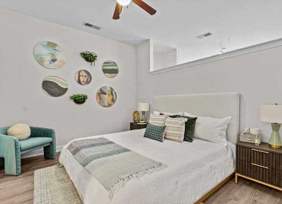 a bedroom with a large bed and a ceiling fan