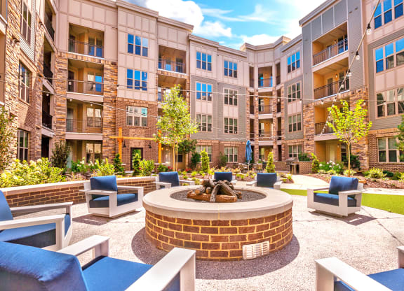 an outdoor courtyard with a fire pit and lounge chairs at Artesia Big Creek, Alpharetta, GA, 30005