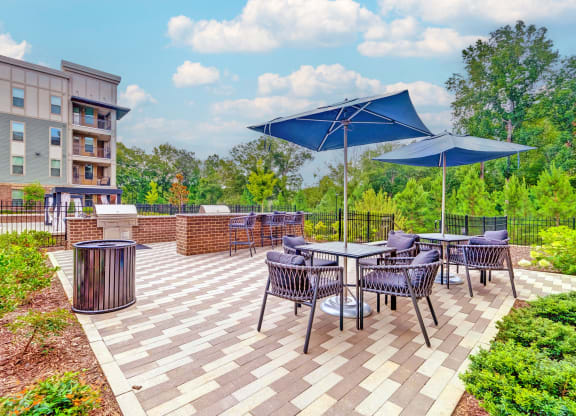 the reserve at bucklin hill patio with tables and umbrellas at Artesia Big Creek, Alpharetta, GA, 30005