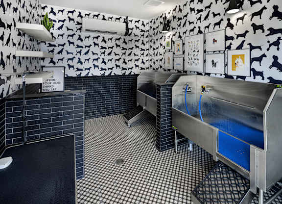 A room with a black and white checkered floor and a wall covered in black and white animal prints at Folksong Apartments, Flowery Branch, 30542