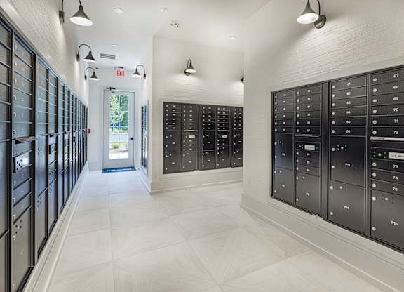 A long hallway with mailboxes on the wall at Folksong Apartments, Georgia