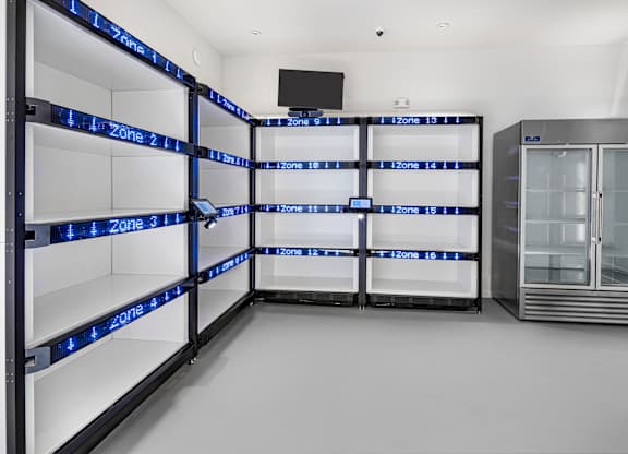 A series of refrigerators are lined up in a row with zone numbers on the shelves at Folksong Apartments, Georgia 30542