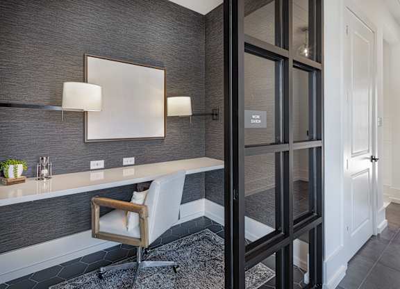 A modern bathroom with a chair and a mirror at Folksong Apartments, Flowery Branch, GA