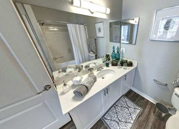 Bathroom with a white vanity with a mirror at Tuscany Bay Apartments, Tampa, FL