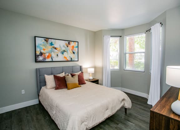 Octave Apartments a bedroom with a bed and two windows at Octave Apartments, Nevada