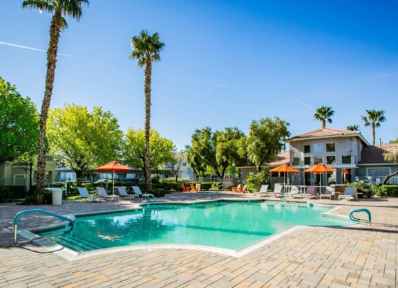 Octave Apartments in Las Vegas, Nevada Clubhouse Exterior and Large Pool with Lounge Chairs at Octave Apartments, Nevada