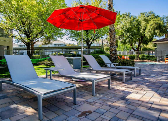 Octave Apartments in Las Vegas, Nevada Poolside Lounge Chairs and Umbrella at Octave Apartments, Nevada, 89123