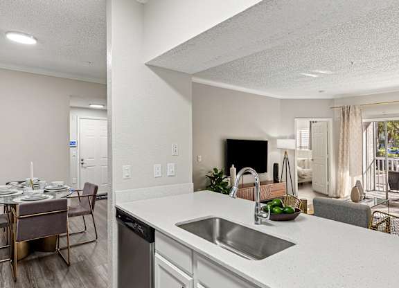 A modern kitchen with a dining table set for four.