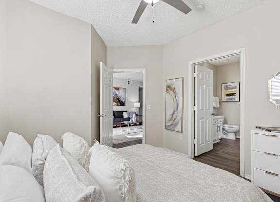 A bedroom with a bed, dresser, and mirror.