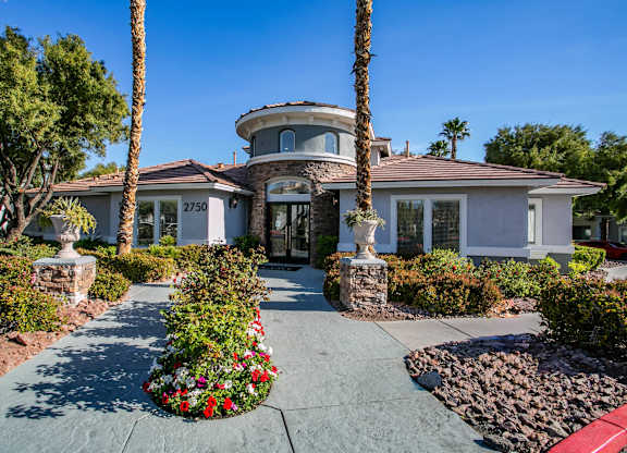 A clubhouse exterior with landscaping in front. at Octave Apartments, Las Vegas, 89123