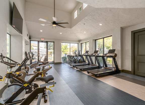 A gym with treadmills and exercise bikes.
