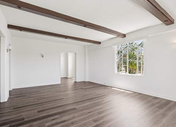 A room with wooden floors and white walls.