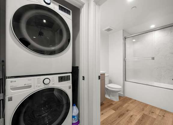 A white washing machine and dryer in a small laundry room.