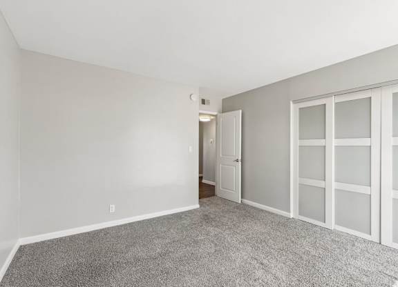 A room with a carpeted floor and white walls.