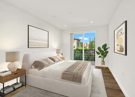 A bedroom with a large bed and a view of the city.