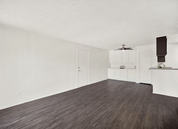A room with a ceiling fan and a kitchenette at Monterra Ridge Apartments, Canyon Country, California