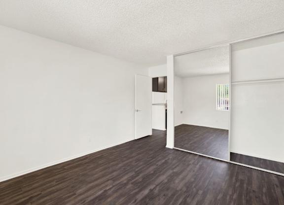 A room with wooden floors and white walls at Monterra Ridge Apartments, Canyon Country, California
