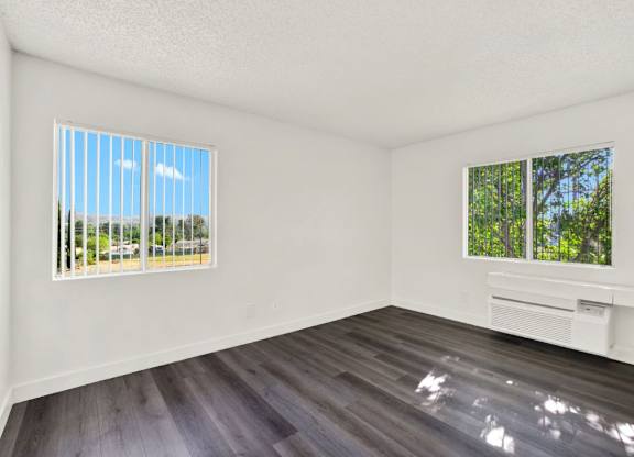 A room with a window and a wooden floor at Monterra Ridge Apartments, Canyon Country