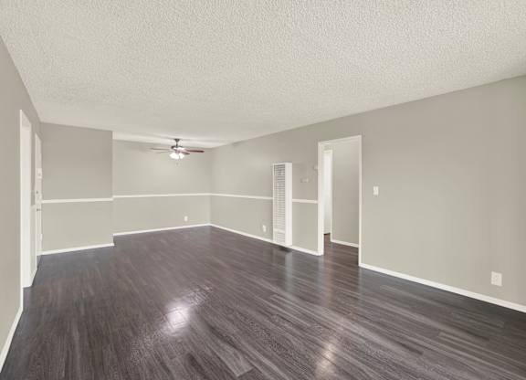 A large empty room with wooden floors and white walls at The Square in Downey, CA, 90242