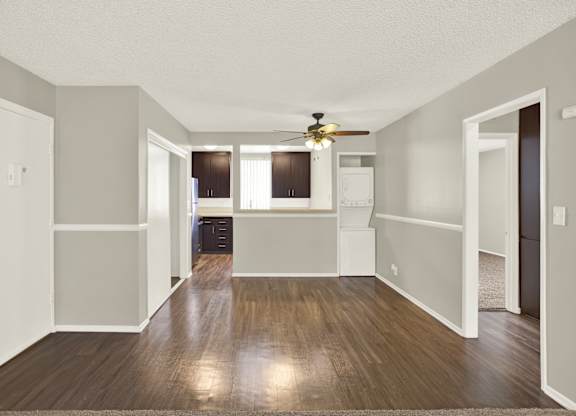 A room with a ceiling fan and wooden floors at The Square in Downey, CA, 90242