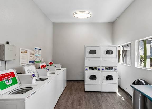 A laundry room with washers and dryers.