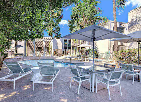 Poolside patio with dining table and sun loungers at Parc @ 5 Apartments, California, 90240