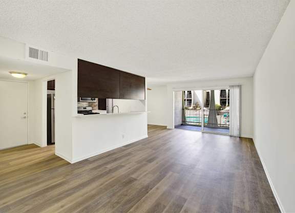 Open concept living room with kitchen peninsula at Parc @ 5 Apartments, Downey, California