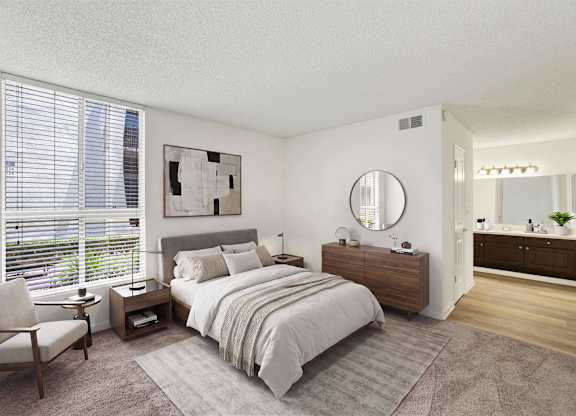 Modern bedroom with ensuite bathroom and large windows at Parc @ 5 Apartments, Downey